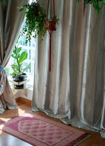 Pray and worship area room at home for Muslim. Islamic prayer rug with hanging green plants with sunlights coming from the window. Beautiful Interior Design.